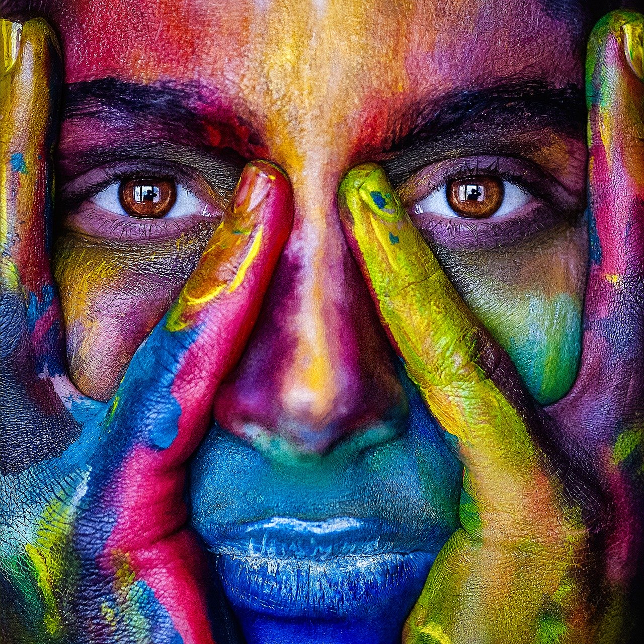 woman with brightly colored rainbow face paint