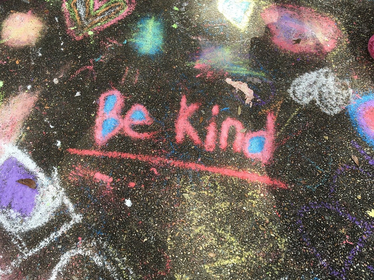 colorful sidewalk chalk that says be kind
